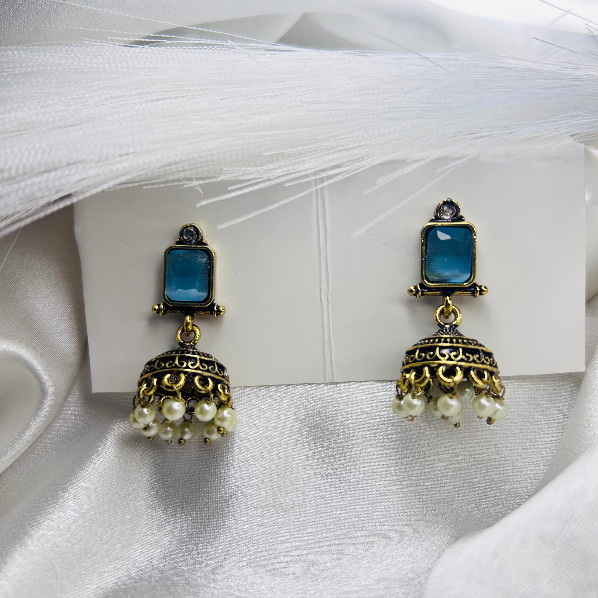 Golden Tone Ethnic Jhumka Earrings with Square Sky Blue Stone